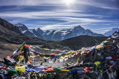 Multi colored flags on mountains against sky