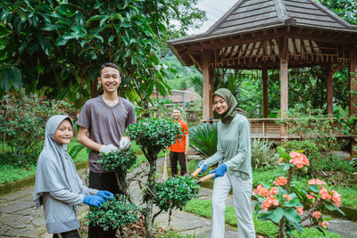 Portrait of senior couple standing by plants