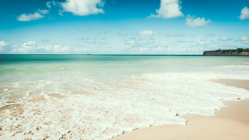 Scenic view of sea against cloudy sky