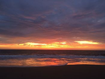 Scenic view of sea against romantic sky at sunset