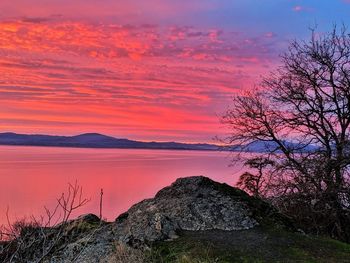 Scenic view of sea against romantic sky at sunset