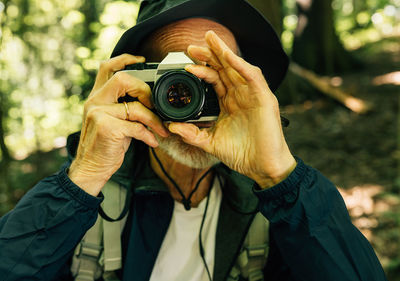 Midsection of woman holding camera