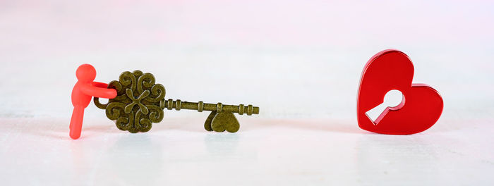 Close-up of toys on table against white background