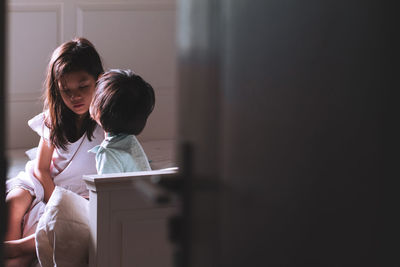 Rear view of mother holding girl