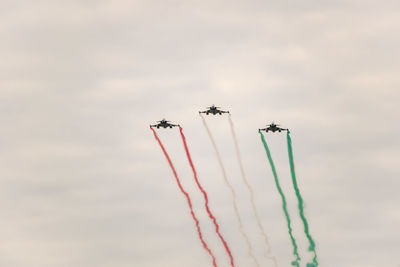 Low angle view of airshow against sky