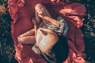 High angle view of woman sitting outdoors