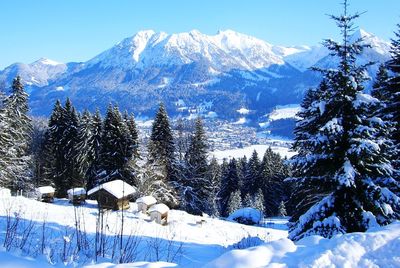 Snow covered land and mountains against sky