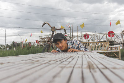 Portrait of young man against sky