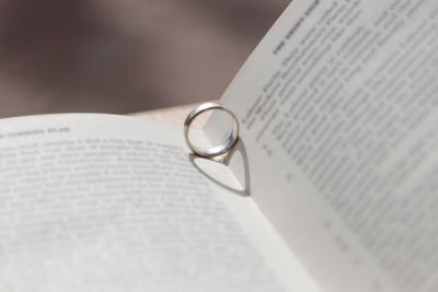 Close-up of open book with ring