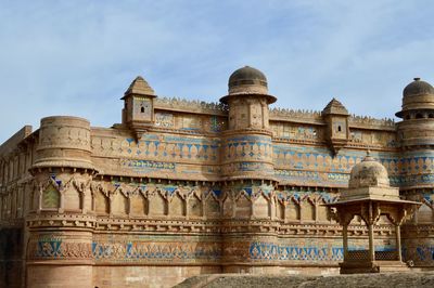 Low angle view of gwalior fort against sky