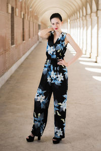 Young woman standing in corridor