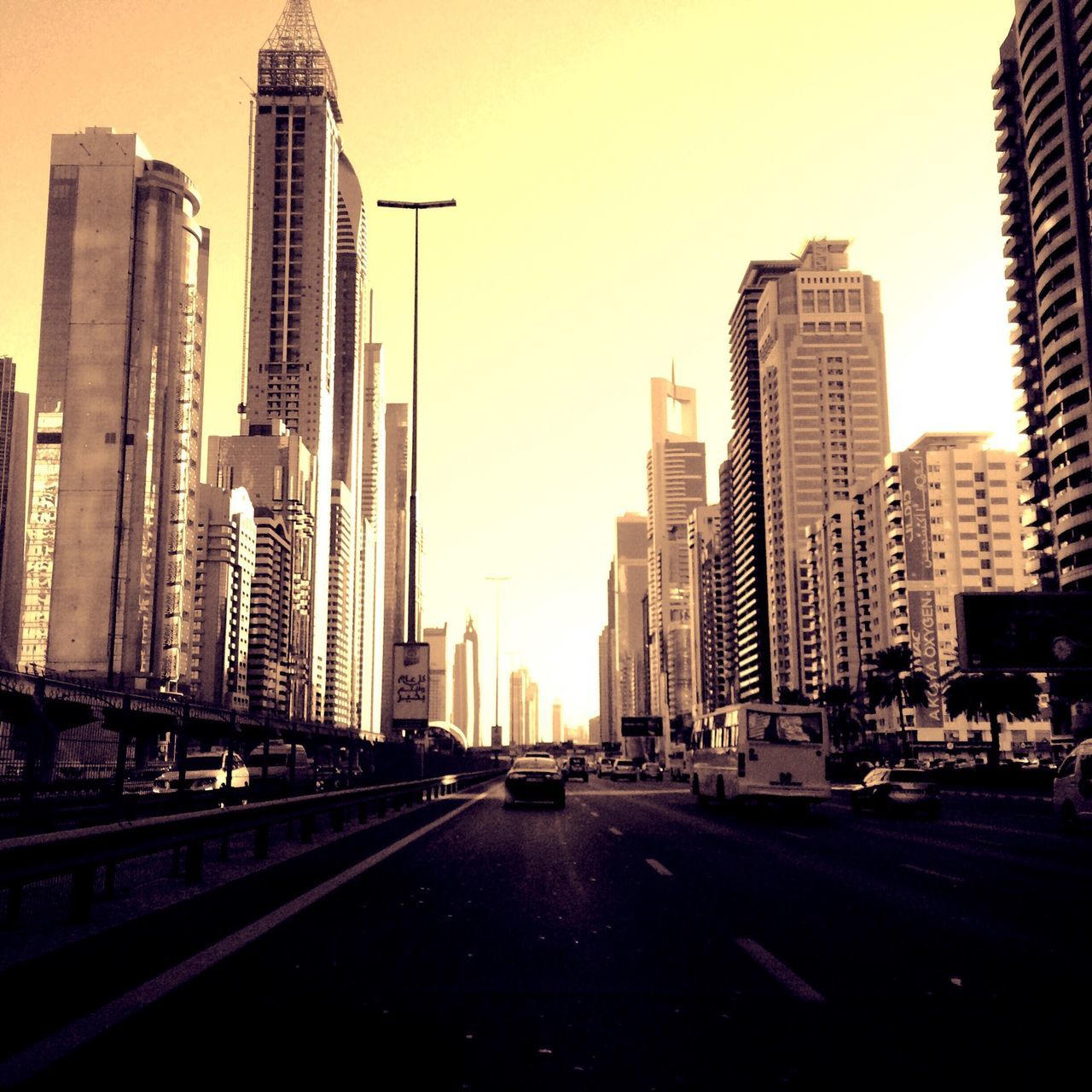 building exterior, architecture, city, built structure, skyscraper, tall - high, office building, modern, tower, the way forward, transportation, street, financial district, road, city life, cityscape, urban skyline, car, building, diminishing perspective