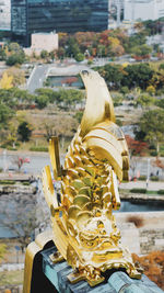 Close-up of statue against buildings in city