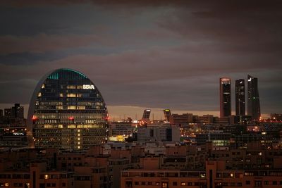 Illuminated cityscape against sky