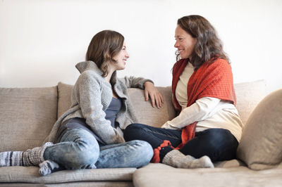 Mother and teenage daughter on sofa
