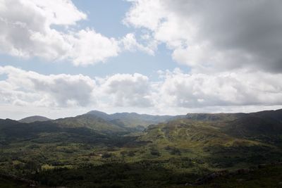 Scenic view of mountains against cloudy sky