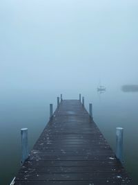 Pier over sea against clear sky