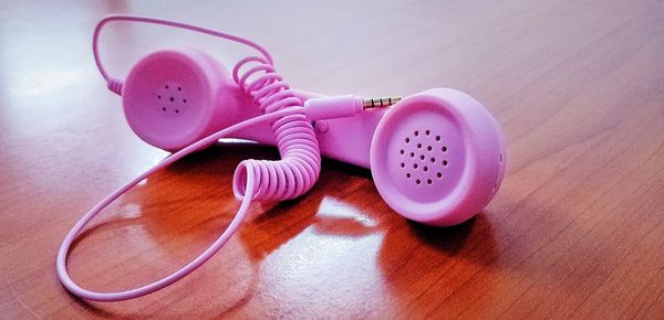 High angle view of telephone receiver toy on wooden table