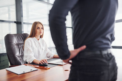 Midsection of business colleagues working at office