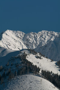 Scenic view of snowcapped mountains against clear sky