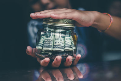 Close-up of hand holding glass jar