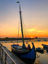 Sailboats in marina at sunset