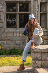 A girl sitting on old stone structure