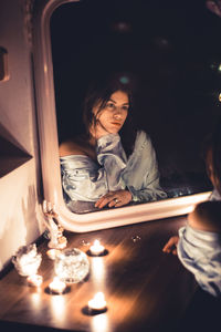 Reflection of woman on mirror in darkroom