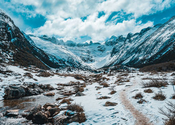 Scenic view of snow covered mountains against sky