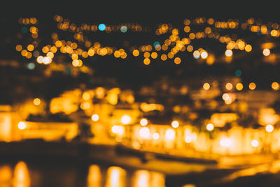 Defocused image of illuminated city at night