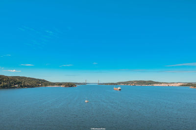 Scenic view of bay against blue sky