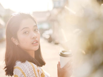 Portrait of woman drinking coffee