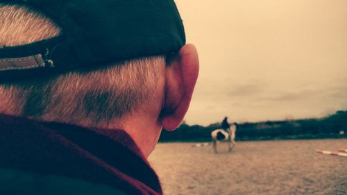 Cropped image of man with horseback rider on background