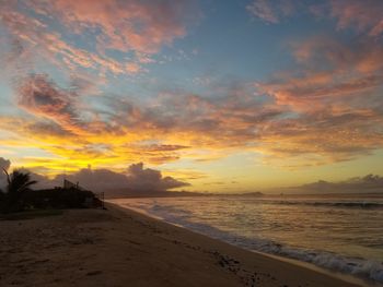 Scenic view of beach against sky during sunset
