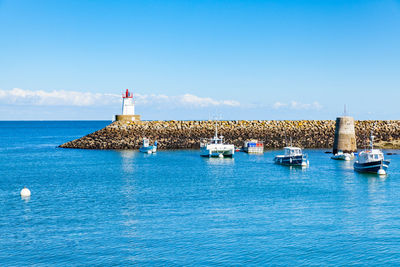 Sailboats on sea against sky