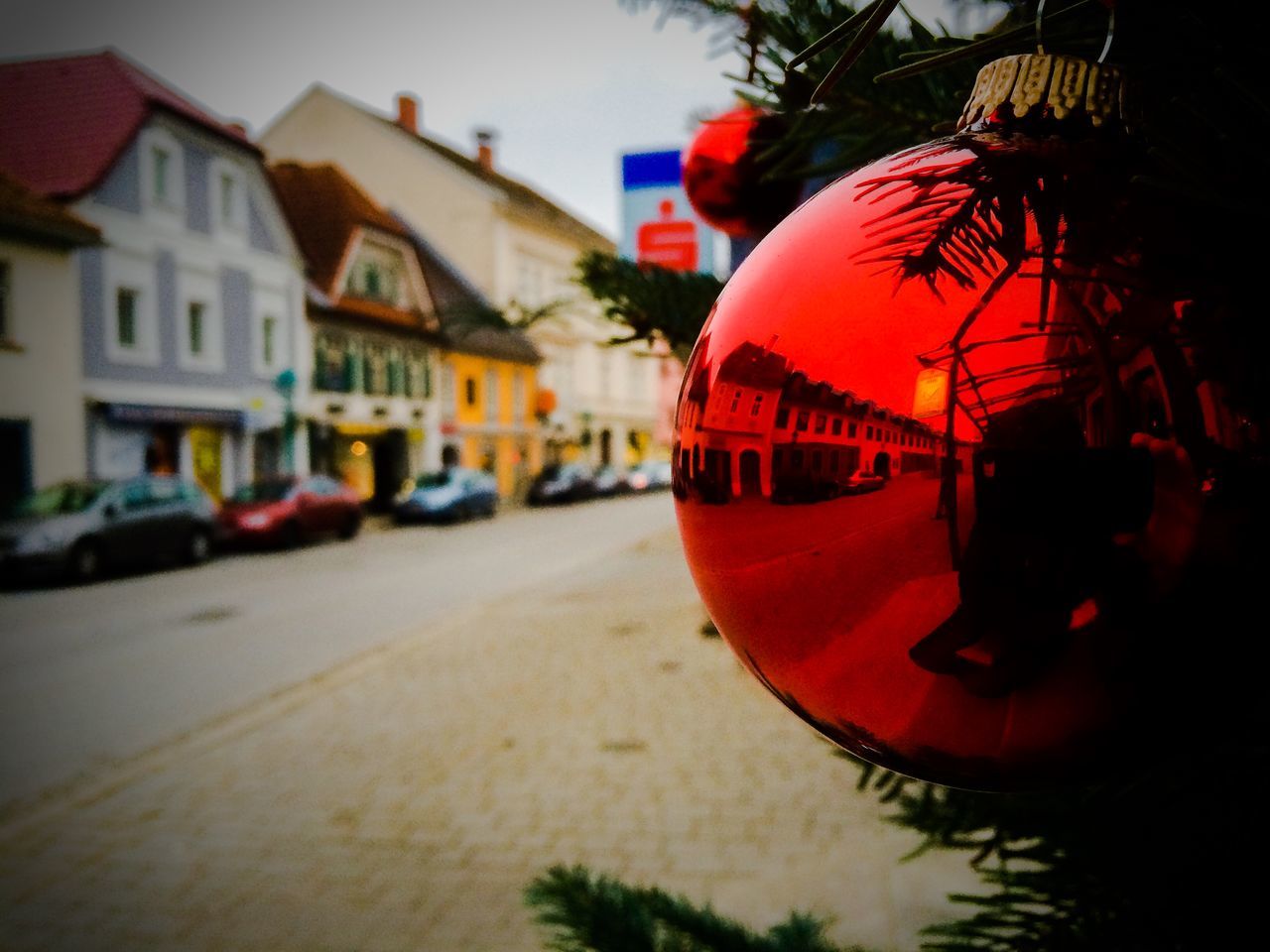 building exterior, architecture, built structure, street, city, focus on foreground, transportation, red, incidental people, car, mode of transport, outdoors, illuminated, building, close-up, land vehicle, road, no people, city street, city life