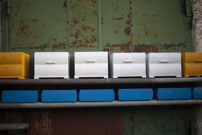 Painted hives are dried in the street. painted wooden boxes in the workshop. 