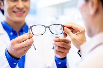 Midsection of doctor examining patient in hospital