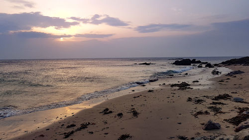 Scenic view of beach against sky during sunset