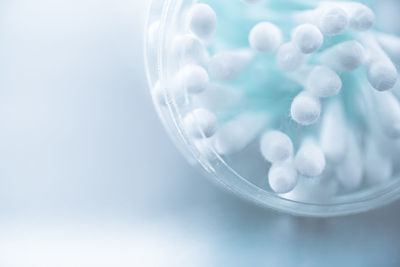 Close-up of cotton swabs over white background