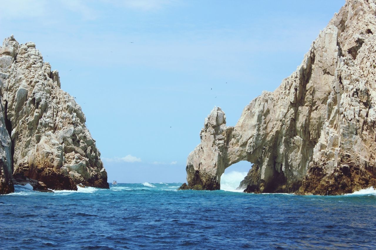 sea, water, rock formation, scenics, waterfront, cliff, beauty in nature, rock - object, tranquil scene, tranquility, blue, nature, horizon over water, sky, rock, idyllic, mountain, rocky mountains, day, clear sky