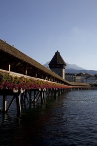 Pier over lake against clear sky