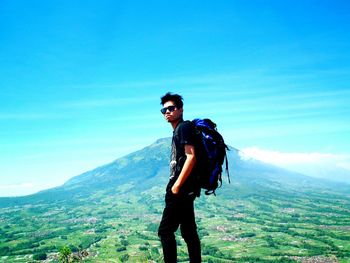 Portrait of young man standing on mountain