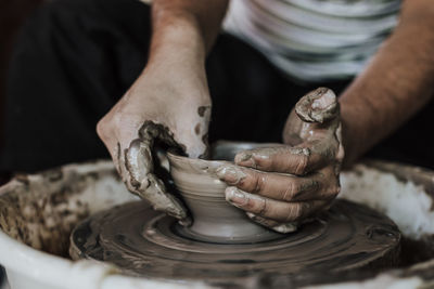 Close-up of artist making pot at workshop