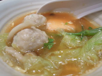 Close-up of serving soup in bowl