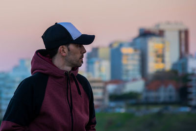 Man looking at cityscape during sunset