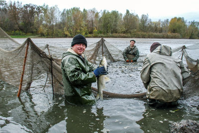 Men sitting on riverbank