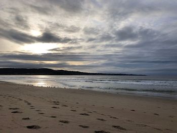 Scenic view of beach against sky during sunset