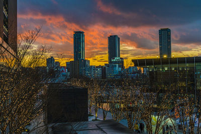 View of buildings against cloudy sky during sunset