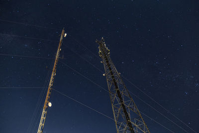 Low angle view of cables against sky at night